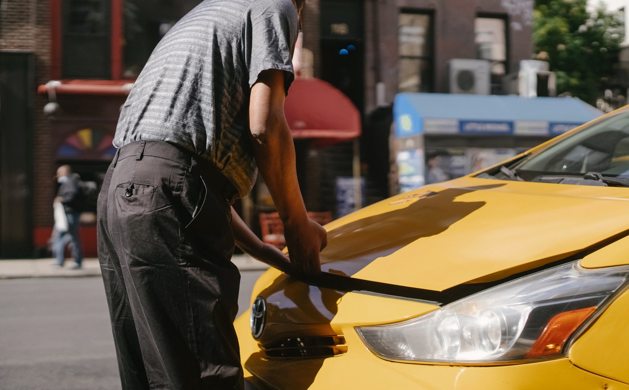 Man opening a car's hood